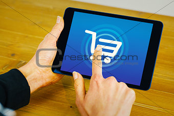 Composite image of businesswoman using tablet at desk