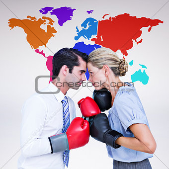Composite image of business people wearing and boxing red gloves