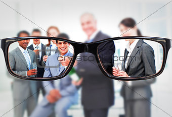 Composite image of businessman opening a bottle of champagne to celebrate a success
