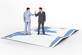 Composite image of businessmen shaking hands