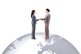 Composite image of two businesswomen shaking hands