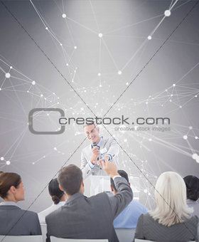 Composite image of businessman doing speech during meeting