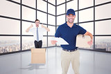 Composite image of happy delivery man with cardboard box and clipboard