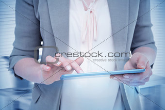 Composite image of close up of woman using tablet