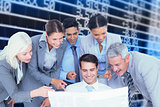 Composite image of happy business people looking at newspaper