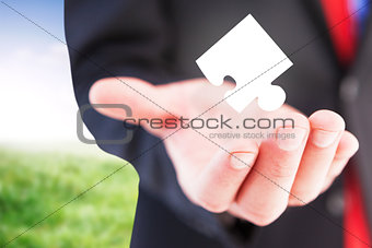 Composite image of businessman presenting with his hand
