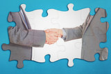 Composite image of close up on two businesspeople shaking hands