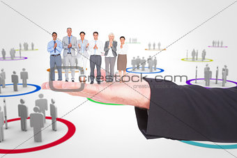 Composite image of smiling business people applauding