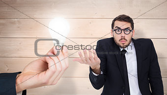 Composite image of doubtful businessman with glasses gesturing