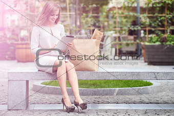 woman using  the tablet while shopping