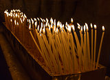 Rows of burning candles .