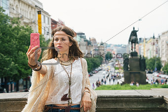 Trendy hippie woman making selfie on Wenceslas Square, Prague