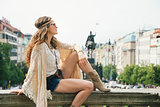 Young hippy-looking woman tourist enjoying sightseeing in Prague