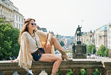 Happy bohemian woman tourist enjoying sightseeing in Prague