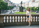 Woman tourist in boho chic clothes standing on Wenceslas Square