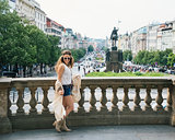 Trendy hippie woman tourist walking on Wenceslas Square, Prague