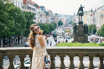 Hippy-looking woman tourist standing on Wenceslas Square, Prague