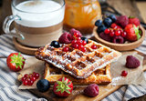Belgian waffles with fresh berries and cappuccino 