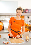 Woman cutting out Halloween biscuits in kitchen