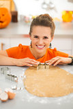 Woman cutting out Halloween cookies with pastry cutter