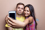 Young couple taking a selfie with mobile phone