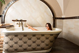brunette girl in a bathtub