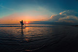 Surfer watching the waves at sunset
