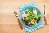 Plate with fresh salad, knife and fork. Diet food