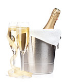 Champagne bottle in ice bucket, two glasses and christmas decor
