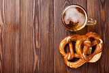 Beer mug and pretzel on wooden table