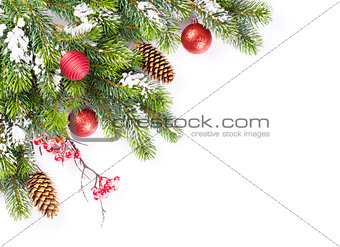 Christmas tree branch with snow and baubles