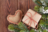 Christmas tree branch with gift box and heart toy