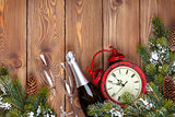 Christmas wooden background with clock, fir tree and champagne
