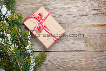 Christmas fir tree with snow and gift box