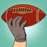 The ball of American football in his hand