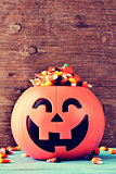 carved pumpkin full of halloween candies