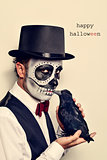 man with calaveras makeup and crow, and text happy halloween