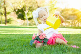 Little Girl Playing Gardener with Her Tools and Flower Pot