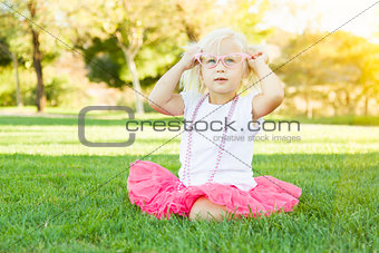 Little Girl Playing Dress Up With Pink Glasses and Necklace