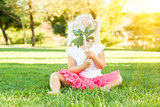 Little Girl In Grass Blowing On Pinwheel