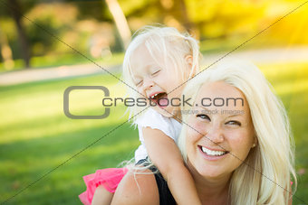 Mother and Little Girl Having Fun Together in Grass
