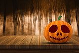 3D Halloween pumpkin on a wooden table with defocussed foggy for