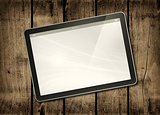 Digital tablet PC on a dark wood table