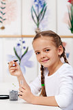 Young girl with seedling for study in biology class