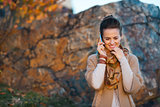 Woman talking cell phone while walking in autumn outdoors