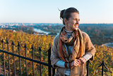 Portrait of relaxed brunette woman in evening autumn park