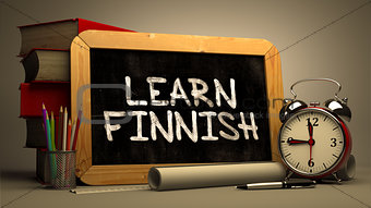 Hand Drawn Learn Finnish Concept on Chalkboard.