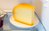Cheese in the fridge with the door open
