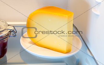 Cheese in the fridge with the door open