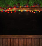 Christmas lights on wooden blackboard